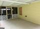Attached screened porch with a yellow exterior and decorative railing; great for relaxation at 6190 Douglas Manor Ct, Douglasville, GA 30134