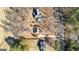 Aerial view of a well-maintained home with mature trees, long driveway, and a neatly landscaped yard at 1585 Lake Dow Rd, Mcdonough, GA 30252