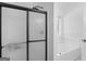 Bathroom featuring a sleek black framed shower and a garden tub with a large bright window at 1585 Lake Dow Rd, Mcdonough, GA 30252