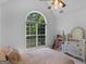 Bright bedroom with large arched window and white walls at 1585 Lake Dow Rd, Mcdonough, GA 30252