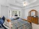 Inviting bedroom with a bright window and desk area, tray ceiling, and comfortable bed at 1585 Lake Dow Rd, Mcdonough, GA 30252