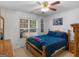 Bedroom with a cozy bed, natural light from the windows, and wood furnishings at 1585 Lake Dow Rd, Mcdonough, GA 30252