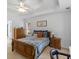 Charming bedroom featuring a tray ceiling, ceiling fan, and coordinating wooden furniture set at 1585 Lake Dow Rd, Mcdonough, GA 30252