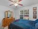 Comfortable bedroom with wood dresser, windows, and wall decor at 1585 Lake Dow Rd, Mcdonough, GA 30252
