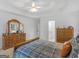 This bedroom boasts a comfortable bed, tray ceiling, and wooden dresser, with attached bathroom at 1585 Lake Dow Rd, Mcdonough, GA 30252