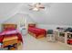 Attic bedroom featuring two twin beds, sloped ceilings, a ceiling fan, and a bright window at 1585 Lake Dow Rd, Mcdonough, GA 30252