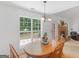 Inviting dining area with wood table, four chairs, view to backyard and living room fireplace at 1585 Lake Dow Rd, Mcdonough, GA 30252