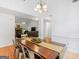Open-concept dining area with hardwood floors and views into the living room at 1585 Lake Dow Rd, Mcdonough, GA 30252