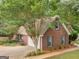 Brick house showing attached garage and landscaping at 1585 Lake Dow Rd, Mcdonough, GA 30252