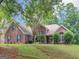 Well-maintained brick home with lush greenery, offering a welcoming and picturesque curb appeal at 1585 Lake Dow Rd, Mcdonough, GA 30252