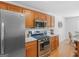 Kitchen featuring stainless steel appliances, granite countertops, and light wood cabinets at 1585 Lake Dow Rd, Mcdonough, GA 30252