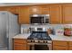 Well-lit kitchen featuring stainless steel appliances and light granite countertops at 1585 Lake Dow Rd, Mcdonough, GA 30252