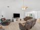 Spacious living room features vaulted ceiling, ceiling fan, TV, and comfortable brown leather seating at 1585 Lake Dow Rd, Mcdonough, GA 30252