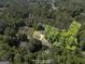 Aerial view of a lake surrounded by trees and neighborhood homes at 96 Ashtonbrook Dr, Mcdonough, GA 30252