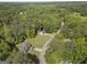 Aerial view of a home and surrounding wooded neighborhood with mature trees and paved roads at 96 Ashtonbrook Dr, Mcdonough, GA 30252