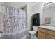 Bathroom featuring a shower with blue-and-white floral shower curtain, vanity, and toilet at 96 Ashtonbrook Dr, Mcdonough, GA 30252
