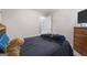 Bedroom with a black bed, blue accents, and neutral walls, creating a cozy atmosphere at 96 Ashtonbrook Dr, Mcdonough, GA 30252