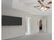 Large bedroom with a tray ceiling, fan, carpeted floors, and a mounted TV at 96 Ashtonbrook Dr, Mcdonough, GA 30252