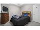 Bedroom featuring a black bed, wooden dresser, and neutral walls, creating a warm atmosphere at 96 Ashtonbrook Dr, Mcdonough, GA 30252
