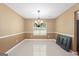 Dining room featuring tile floors, chair-rail molding, and contemporary light fixture at 96 Ashtonbrook Dr, Mcdonough, GA 30252
