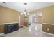 Open dining room with a view of the living room, featuring stylish light fixture and tile floors at 96 Ashtonbrook Dr, Mcdonough, GA 30252