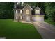 Two-story brick home at dusk with blue shutters, a two-car garage and well-maintained lawn at 96 Ashtonbrook Dr, Mcdonough, GA 30252