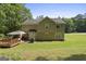 Rear view of a two-story home featuring a deck with gazebo and mature landscaping at 96 Ashtonbrook Dr, Mcdonough, GA 30252