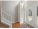 Bright foyer with hardwood floors, a staircase, and a stylish front door with glass accents at 96 Ashtonbrook Dr, Mcdonough, GA 30252