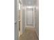 Hallway with carpeted floors and white doors, leading to other rooms in the house at 96 Ashtonbrook Dr, Mcdonough, GA 30252