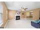 Spacious living room with a cozy fireplace, tile floors, and a ceiling fan at 96 Ashtonbrook Dr, Mcdonough, GA 30252