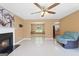 Bright living room with tile floors, a ceiling fan, fireplace, and views of the dining room and kitchen at 96 Ashtonbrook Dr, Mcdonough, GA 30252