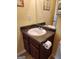 Bathroom featuring a dark wooden vanity, white sink, speckled countertop, and a full mirror at 1441 Saint George Pl, Conyers, GA 30012