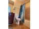 Bathroom features a toilet, vanity with dark wood cabinets and a shower with blue curtain at 1441 Saint George Pl, Conyers, GA 30012