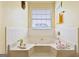 Relaxing bathtub area with jets, window, and towel rack, creating a serene space for unwinding and self-care at 1441 Saint George Pl, Conyers, GA 30012