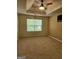 Bright bedroom with neutral walls, tray ceiling, ceiling fan, and natural light at 1441 Saint George Pl, Conyers, GA 30012
