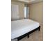 Bright bedroom with a modern platform bed, neutral walls, and carpeting at 1441 Saint George Pl, Conyers, GA 30012