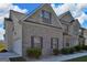 Charming home with brick facade, lush greenery, and a convenient side-entry garage adding to its appeal at 1441 Saint George Pl, Conyers, GA 30012