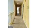 Well-lit hallway with plush carpeting and contrasting trim detail for a warm, inviting space at 1441 Saint George Pl, Conyers, GA 30012
