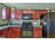 This functional kitchen features wood cabinets, practical appliances, and ample counter space for meal preparation at 1441 Saint George Pl, Conyers, GA 30012