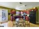 Functional kitchen with rich wood cabinetry, modern appliances, and a breakfast nook bathed in natural light at 1441 Saint George Pl, Conyers, GA 30012