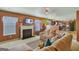 Inviting living room featuring a cozy fireplace, plush sofa, and a seamless flow to the kitchen and dining area at 1441 Saint George Pl, Conyers, GA 30012