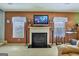 Living room with fireplace, flat screen television and many windows at 1441 Saint George Pl, Conyers, GA 30012