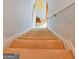 View from the top of carpeted stairs shows the staircase and hallway leading to other rooms in the home at 1441 Saint George Pl, Conyers, GA 30012