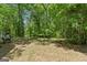 A shady backyard featuring a picnic table and bench at 1627 Leguin Mill Rd, Locust Grove, GA 30248