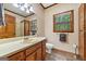 Bathroom featuring a large vanity, toilet, and modern finishes at 1627 Leguin Mill Rd, Locust Grove, GA 30248