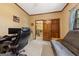 A well-lit bedroom featuring a futon and door to the hallway at 1627 Leguin Mill Rd, Locust Grove, GA 30248