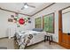 Cozy bedroom with natural light, featuring wood trim and license plate decor at 1627 Leguin Mill Rd, Locust Grove, GA 30248