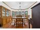 Dining room with wood flooring, chandelier and many windows letting in plenty of natural light at 1627 Leguin Mill Rd, Locust Grove, GA 30248