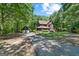 Charming home featuring a long driveway, detached garage and lush surrounding landscape at 1627 Leguin Mill Rd, Locust Grove, GA 30248
