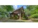 Home exterior featuring wood siding, stone foundation and screened-in porch at 1627 Leguin Mill Rd, Locust Grove, GA 30248